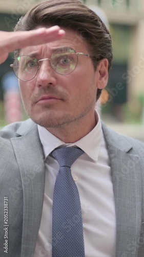 Middle Aged Businessman Looking Around, Searching, vertical video