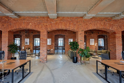 Industrial loft office with brick pillars and green plants