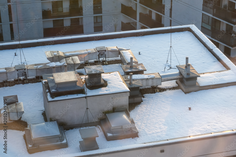Fototapeta premium Snow covered roof with ventilation system