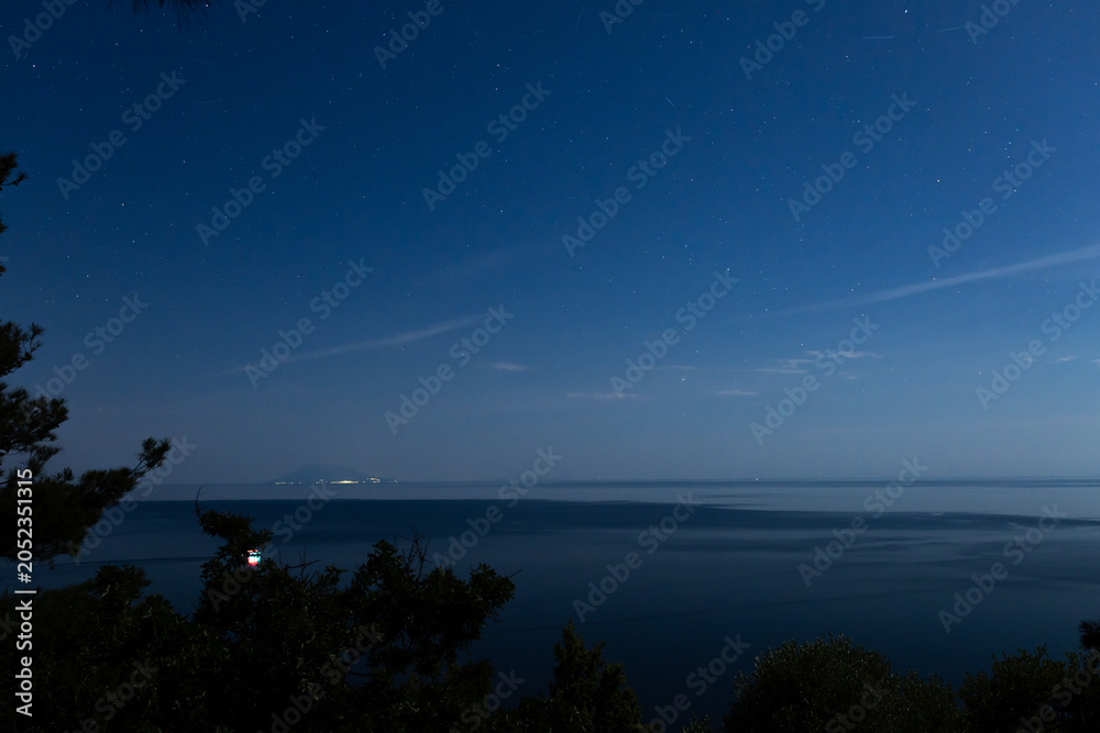 Obraz premium Milky way stars over ocean sea waters.