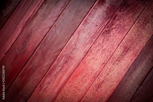 Red brown wooden plank texture background with vignette effect.
