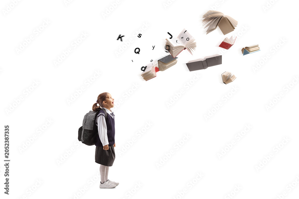 Obraz premium Surprised schoolgirl standing and looking at flying books