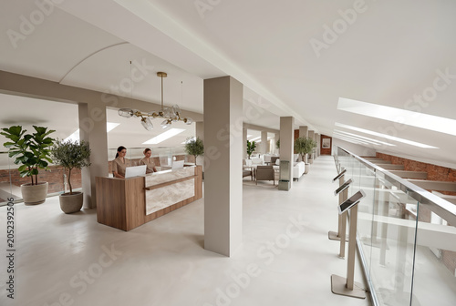Spacious clinic reception with white columns and seating zone