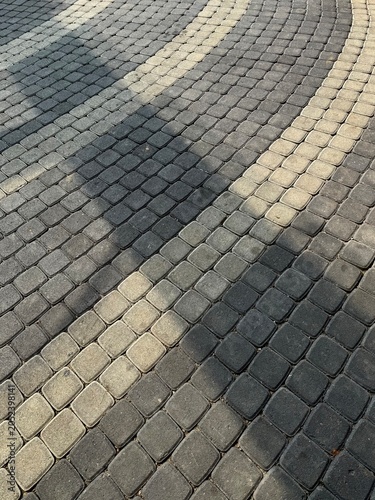 Square stone pavement of street with shadow