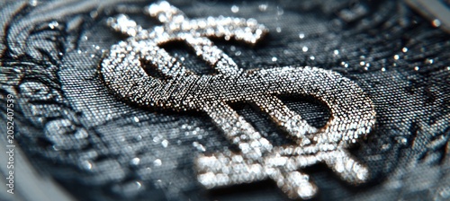 Shimmering diamond-encrusted dollar sign symbol on a black textured background representing wealth, luxury, and success in a detailed macro shot.