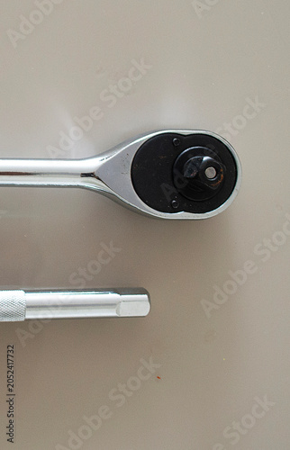 Professional Socket Wrench Ratchet and Extension Tool on Neutral Surface