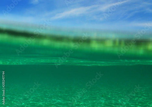 Crystal Clear Turquoise Water Surface with Sandy Seabed Reflections