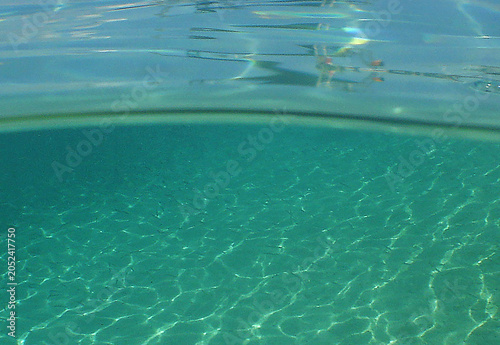 Crystal Clear Turquoise Water Surface with Sandy Seabed Reflections