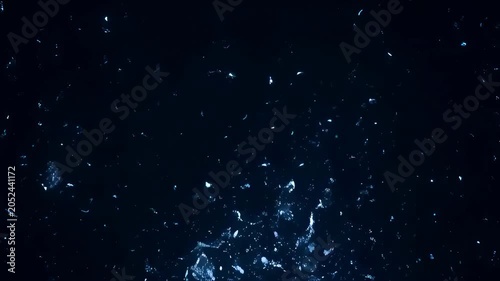 Underwater water splash with bright light, scattered bubbles, and white cracked sphere on dark blue liquid background