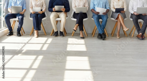 Diverse Candidates Waiting and Working on Devices