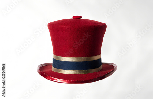 Red top hat with gold and navy blue band on white background  