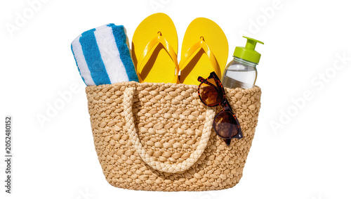 Obraz na płótnie Woven straw beach bag with yellow flip-flops towel sunglasses, and water bottle