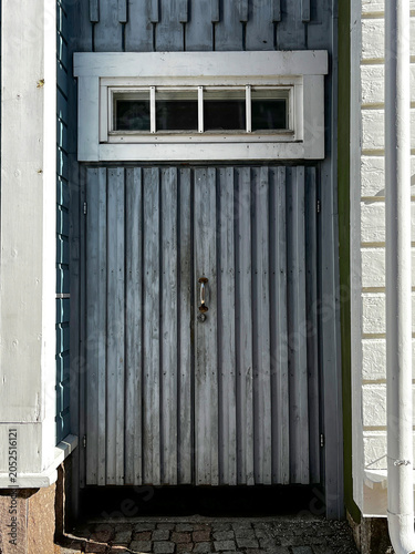 Old Timeworn Wooden Door of Entrance to House on Medieval Street of Porvoo (Borgå) in Finland. Architectural Detail.
