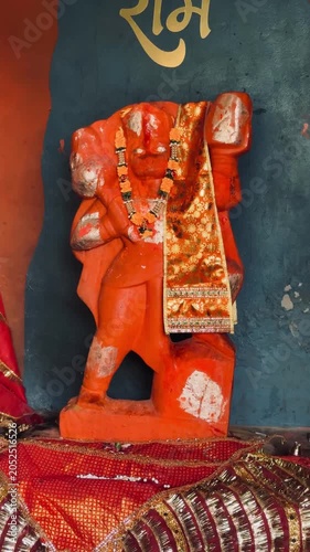 Detailed portrait of Bajrangbali Hanuman idol with folded posture and ceremonial decoration, highlighting divine strength, loyalty, and devotional practices.
