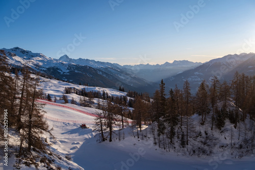Fotografie Sunrise over the Rhone Valley with snow-covered mountains and part of the men's