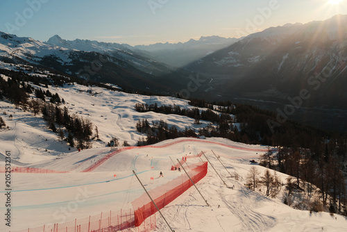 Konstfotografi Sunrise over the Rhone Valley with snow-covered mountains and part of the men's