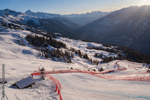 Fotografie Sunrise over the Rhone Valley with snow-covered mountains and part of the men's