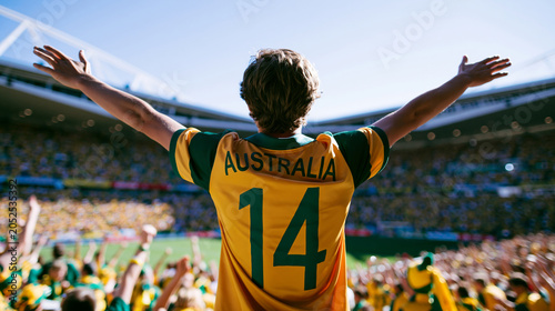 Back view of young male football fan cheering in stadium during world cup