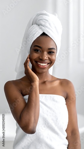 A woman wrapped in a white towel touches her face
