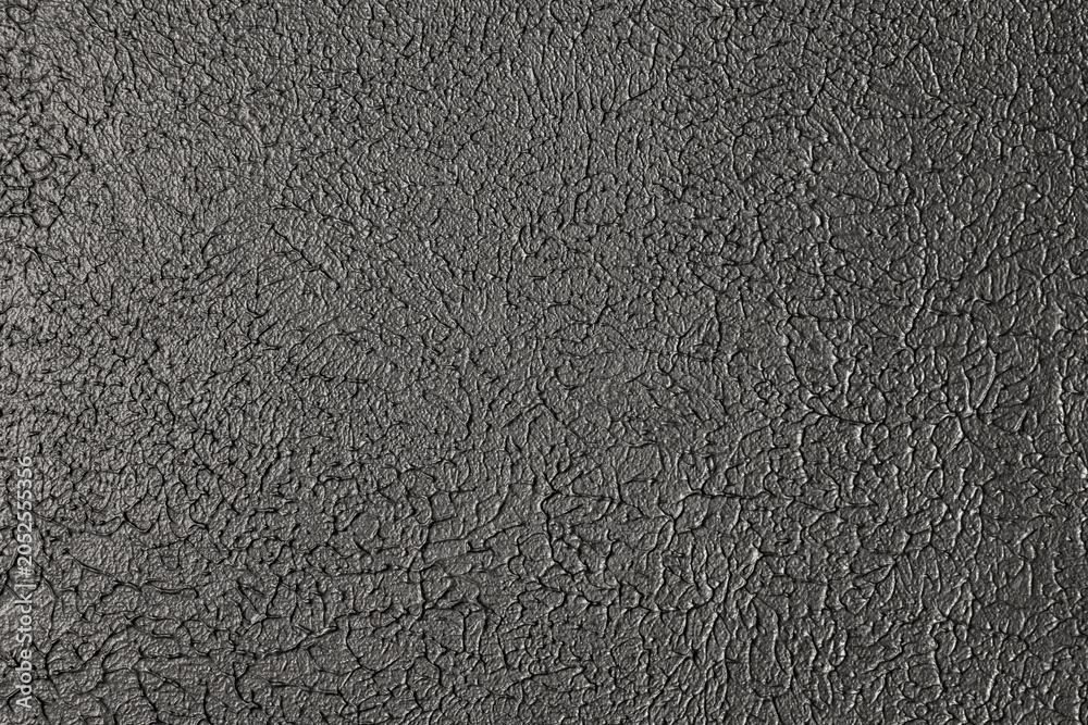 Fototapeta premium Abstract black cracked paint or leather material texture