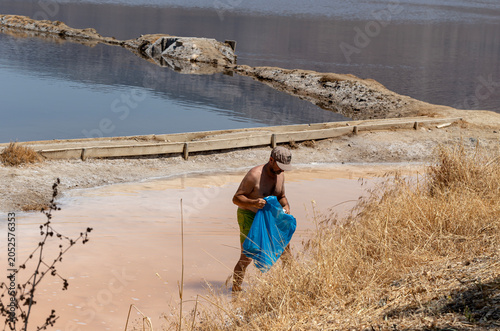 A man collecting salt near a salt lake (Aetolia-Acarnania, Greece)