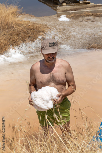 A man collecting salt near a salt lake (Aetolia-Acarnania, Greece)
