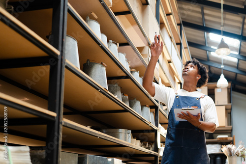 Canvas Print man african american warehouse worker checking merchandise inventory count in st