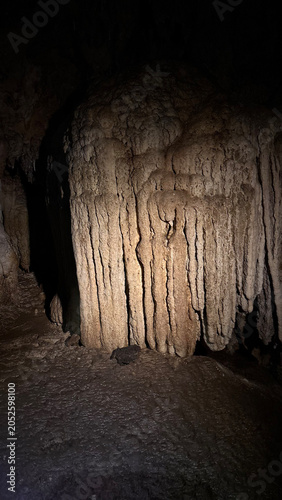 Dramatic Textured Limestone Drapery Illuminated Inside Dark Cave
