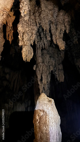 Tall Cave Stalagmite Standing Beneath Hanging Stalactites