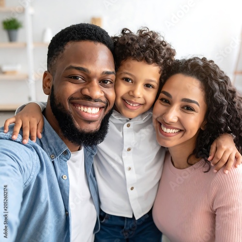 A happy family of three, smiling and posing together indoors