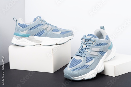 Pair of sneakers on color background