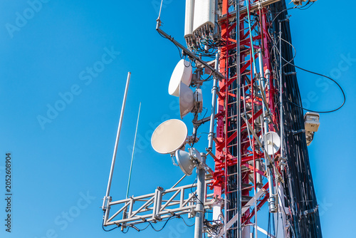 Photography Cellular tower equipment with microwave antennas and communication hardware on t