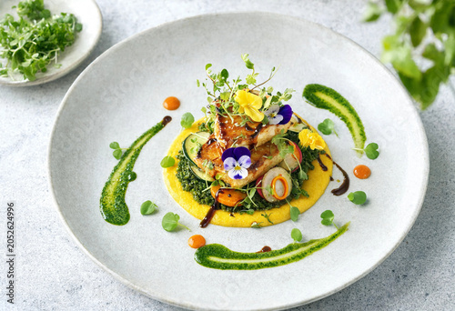 Delicious seafood dish with colorful garnishes on a plate indoors