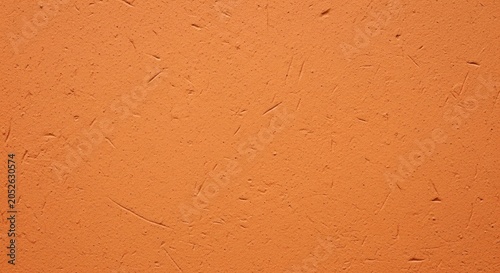 Orange textured plaster wall with subtle scratches grains