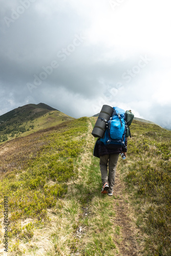 mountain trail along which a tourist walks, green mountain range in the fog, peak, hiking in the mountains, trekking, Carpathians, Pishkonya range