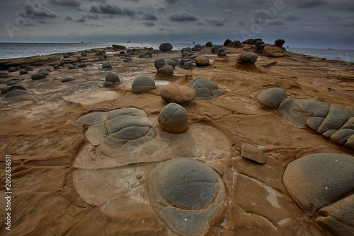 Earth's ancient sculpture garden — an extraordinary field of perfectly rounded concretion boulders emerges from eroded sandstone platforms along the wild, desolate coastline of Lobitos, Piura, Peru.
