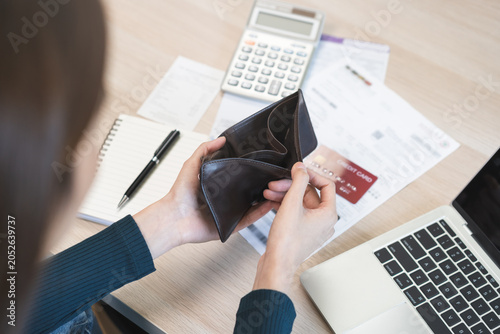 Фотография Debt financial concept, stressed problem asian woman hand open empty wallet, purse not have budget of money to pay no have credit card, not able payment bill, loan or expense with bank, bankruptcy