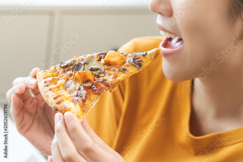 Bild auf Leinwand Happy meal with fast food, pleasure asian young woman, girl hold piece, enjoy ea
