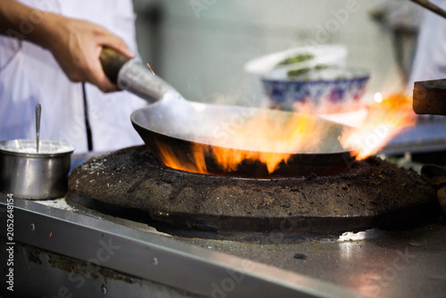 Man cooking at a street food stall, Xi'an, Shaanxi, China