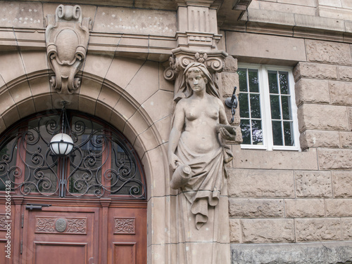 Obraz na plátně Close up of historical building facade detail with atlantes sculpture and stone