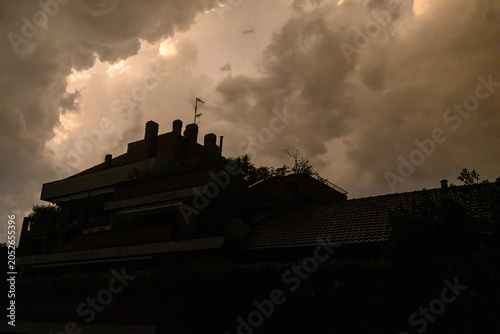 Stormy sky over buildings along via Piero della Francesca in Milan, Italy