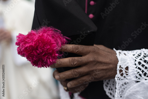 Tableau sur toile Clergyman holding a biretta with a pink pompom
