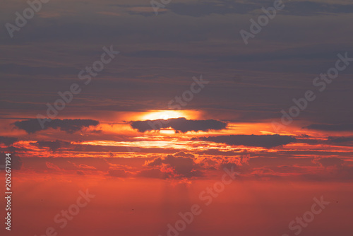 Sky replacement sun peaking through orange sky