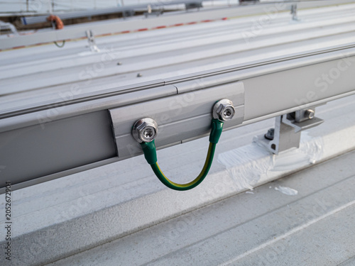 Connect the grounding wire to the rail connection point of the solar panel system.
