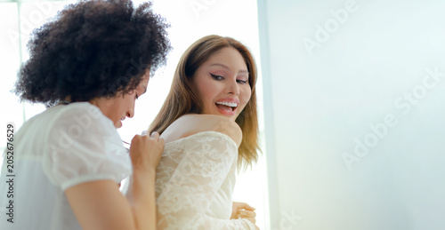 Quadro su tela Lesbian couple deeply in love with a gentle transgender woman celebrate their joyous wedding day together playfully teasing each other conversing kindly and supporting each other
