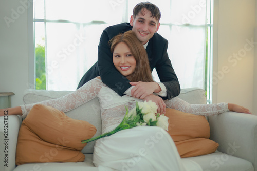 Картината върху платно Married couple sits affectionately expressing their love and goodwill towards each other transgender woman and handsome foreign man sit holding hands gently demonstrating equality
