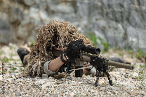 Canvas Print US Military marksman in camouflage ghillie suit conducting precision sniper oper