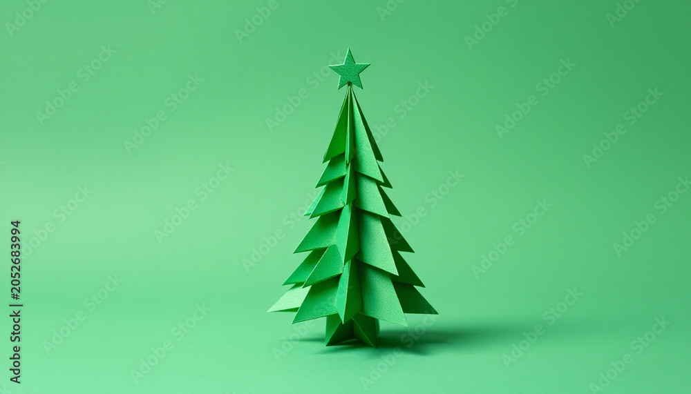 Obraz premium Minimalist Green Origami Christmas Tree Paper Craft on Isolated Background