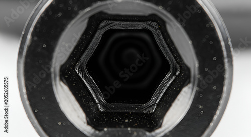 Macro view of a socket wrench head, dark interior