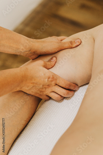 Close up of arm massage therapy session. Female massage therapist's hands.